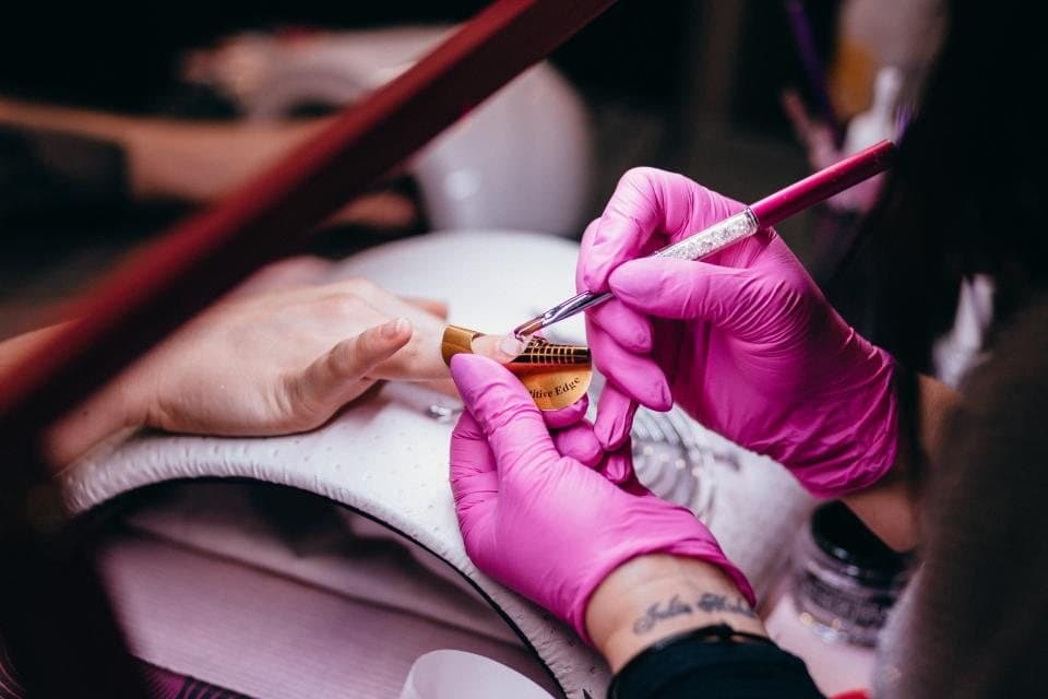 Nail technician painting nails